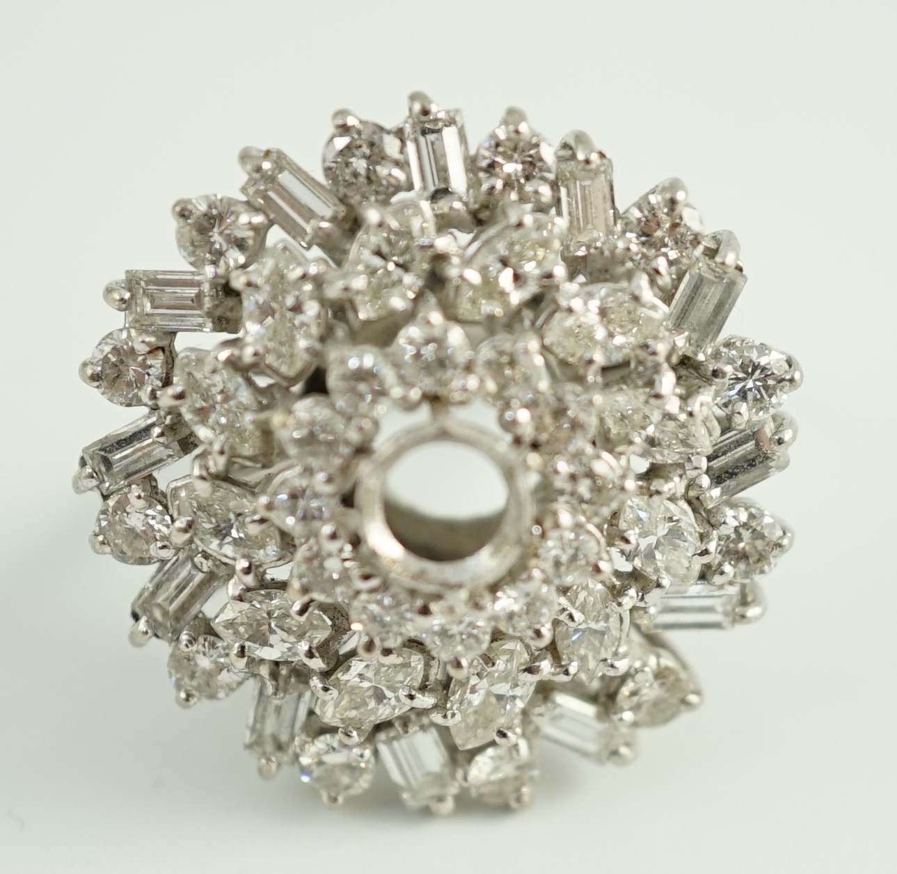 A modern 18ct white gold, ruby and round, baguette and marquise cut diamond cluster set dress ring